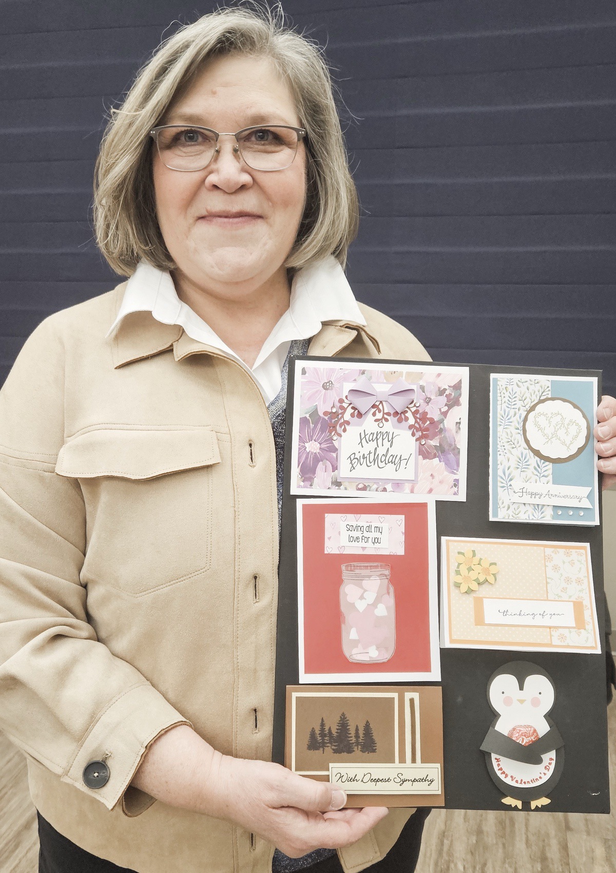 New Greeting Card Instructor Jane Hancock holds a display of cards made by class participants. (Photo by Christine Such/My Sun Day News)