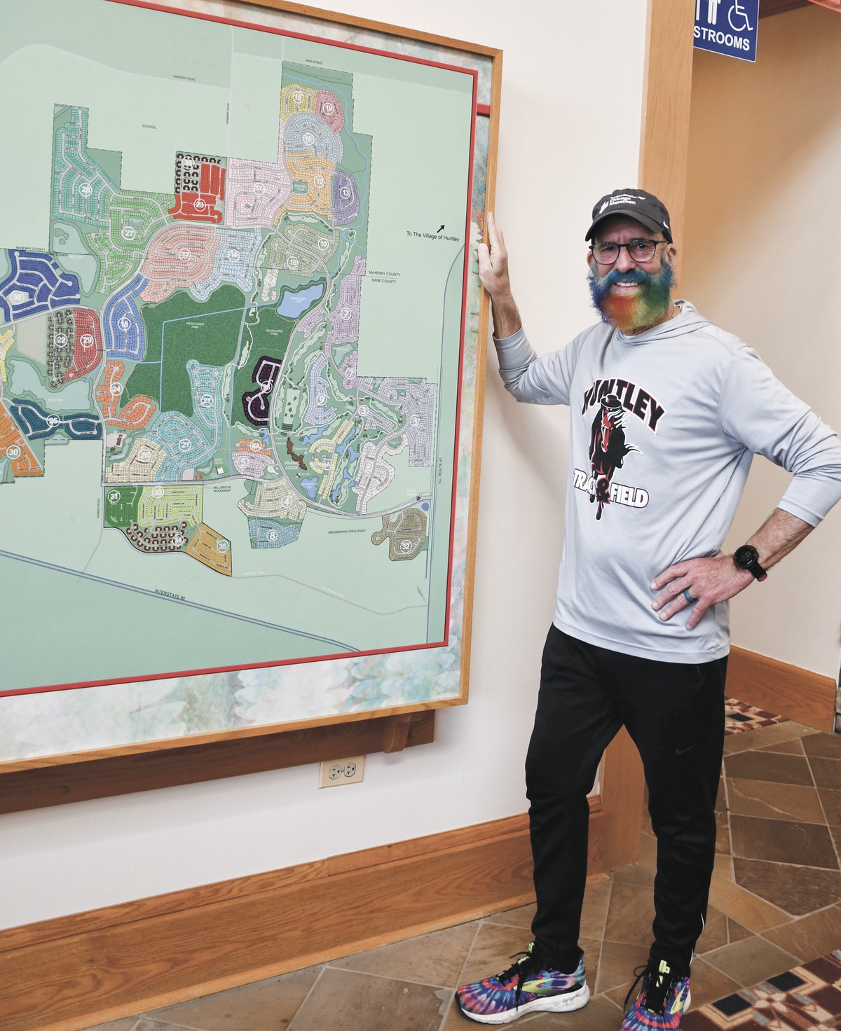 SC resident Todd Kane poses next to a Sun City map. He has for the second time run past every house in the community. (Photos by Christine Such/My Sun Day News)