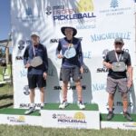 Sun City Huntley resident John Schwan, center, was presented with the gold medal he won at the US Open Pickleball Championships in Naples, Florida April 14. (Photo provided)