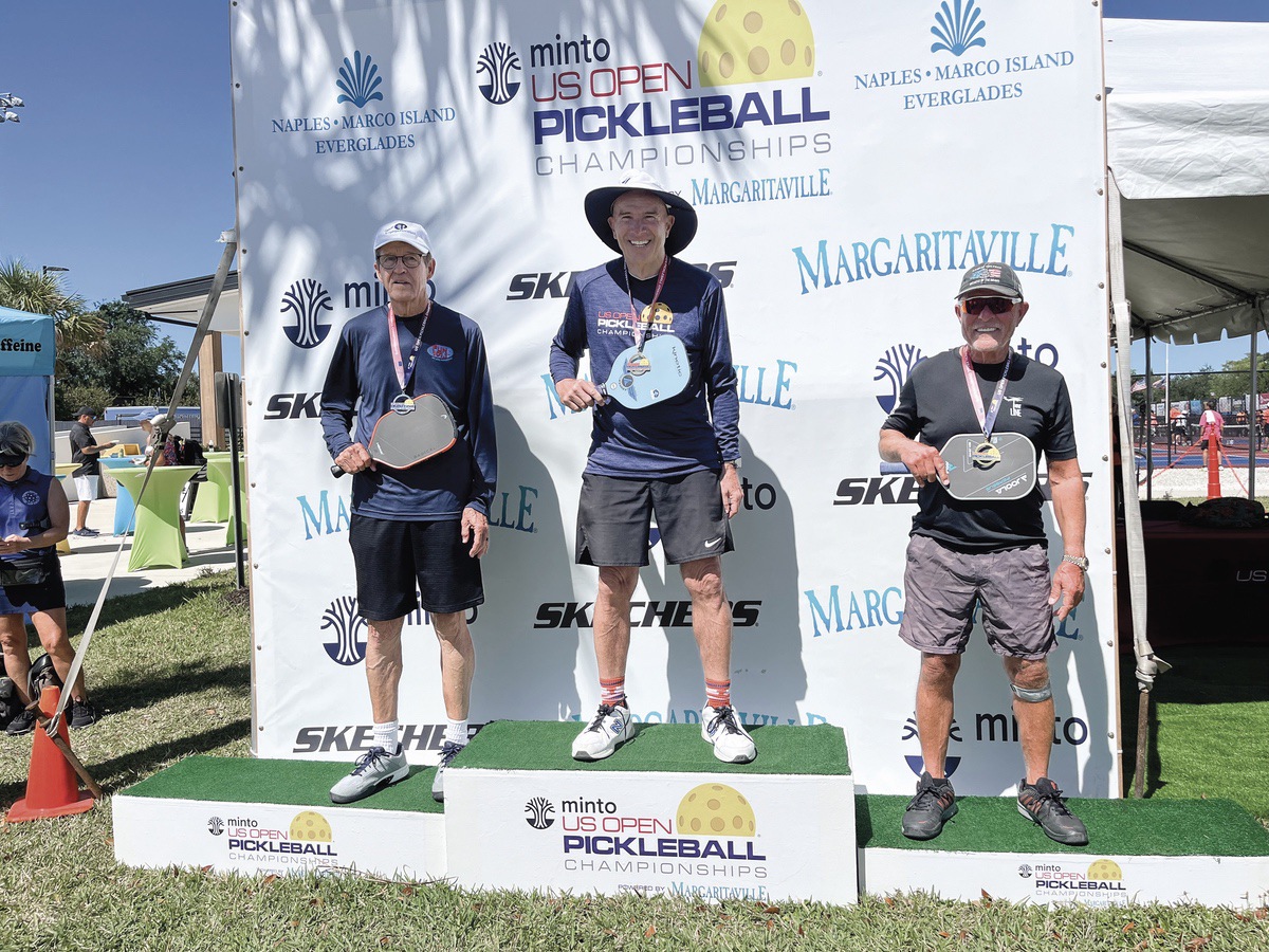 Sun City Huntley resident John Schwan, center, was presented with the gold medal he won at the US Open Pickleball Championships in Naples, Florida April 14. (Photo provided)