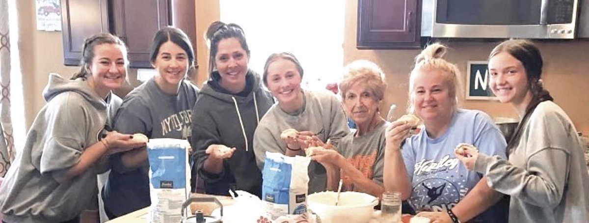 Jacobsen and Bigos with family making pierogis. (Photo provided)