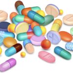 Colored pills and granules medical realistic composition on white vector illustration