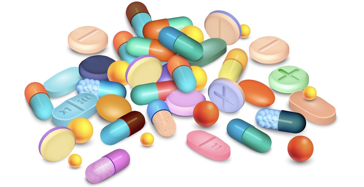 Colored pills and granules medical realistic composition on white vector illustration