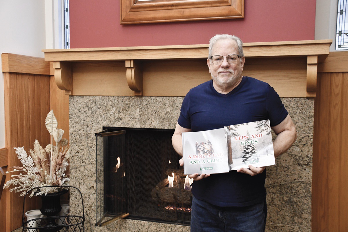 Bill Dollear presents his two published books: Leps and Elves and A Dog, A Cat, and a Crime. (Photo by Christine Such/My Sun Day News)