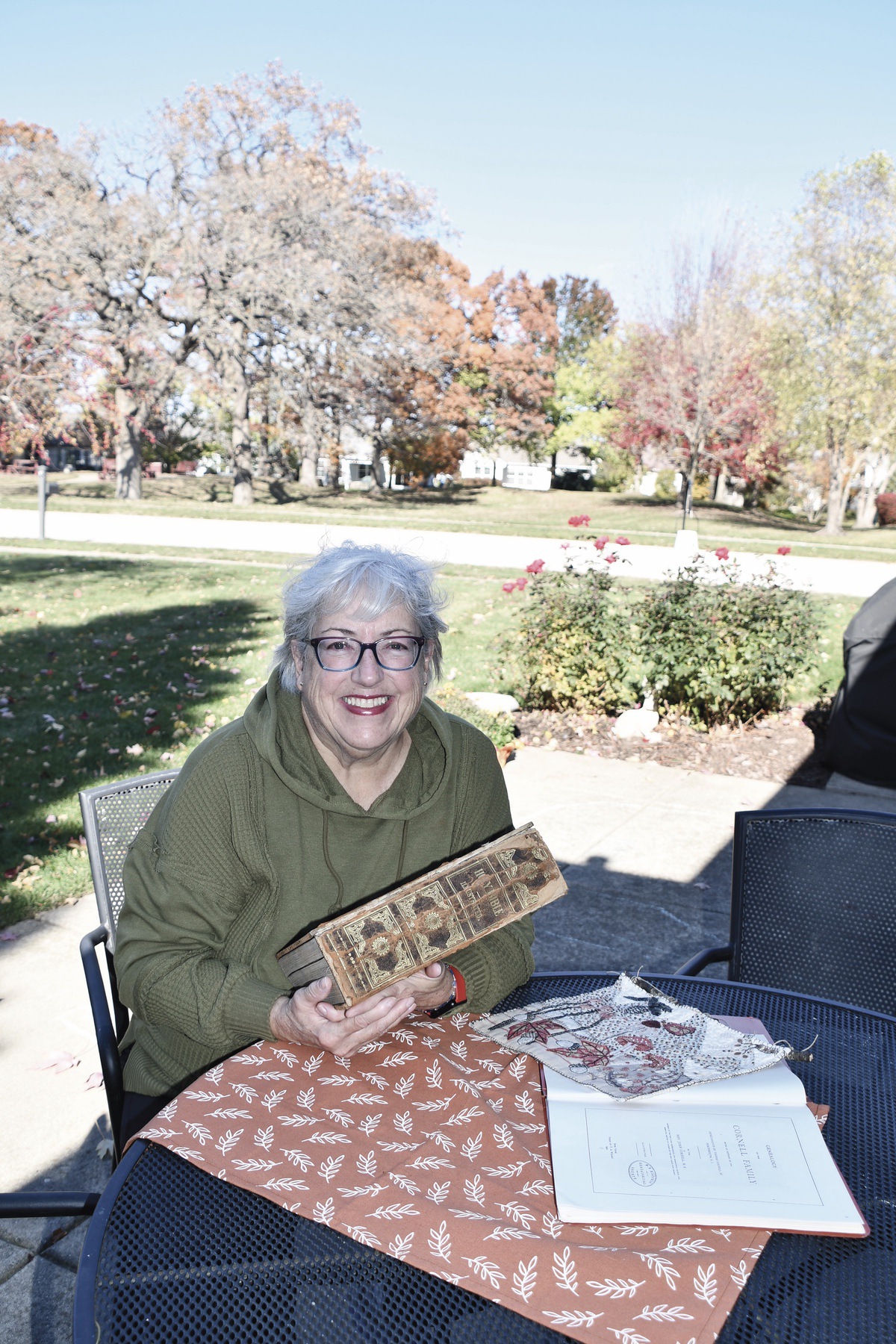 Lucy Tracy holds the book that contains her Cornell family history. (Photo by Christine Such/My Sun Day News)