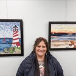 Karen Semancik’s daughter, Julie Wade (above), and husband, J (below), stand proud at the Huntley Area Public Library’s display of Karen’s fabric art. (Photos by Christine Such/My Sun Day News)