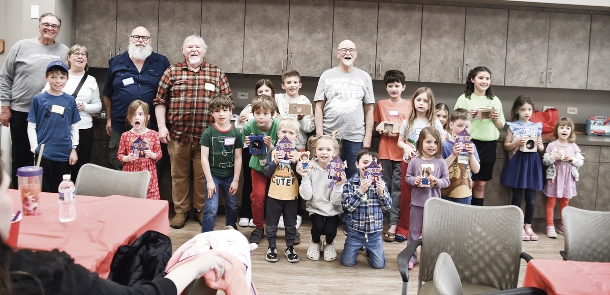 Kids show off their craft projects built with Woodchucks and GG&Me members.