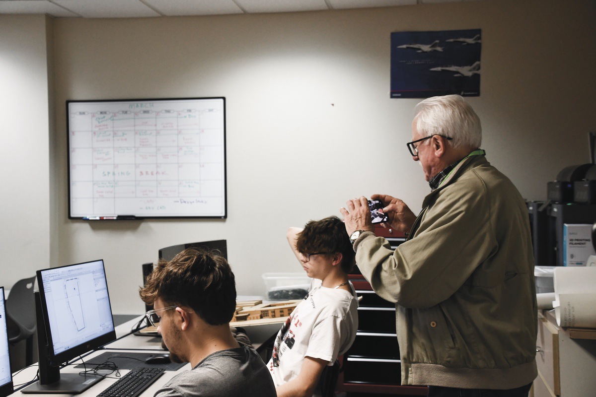 David Applegate works with engineering students on a 3D modeling project of downtown Huntley.