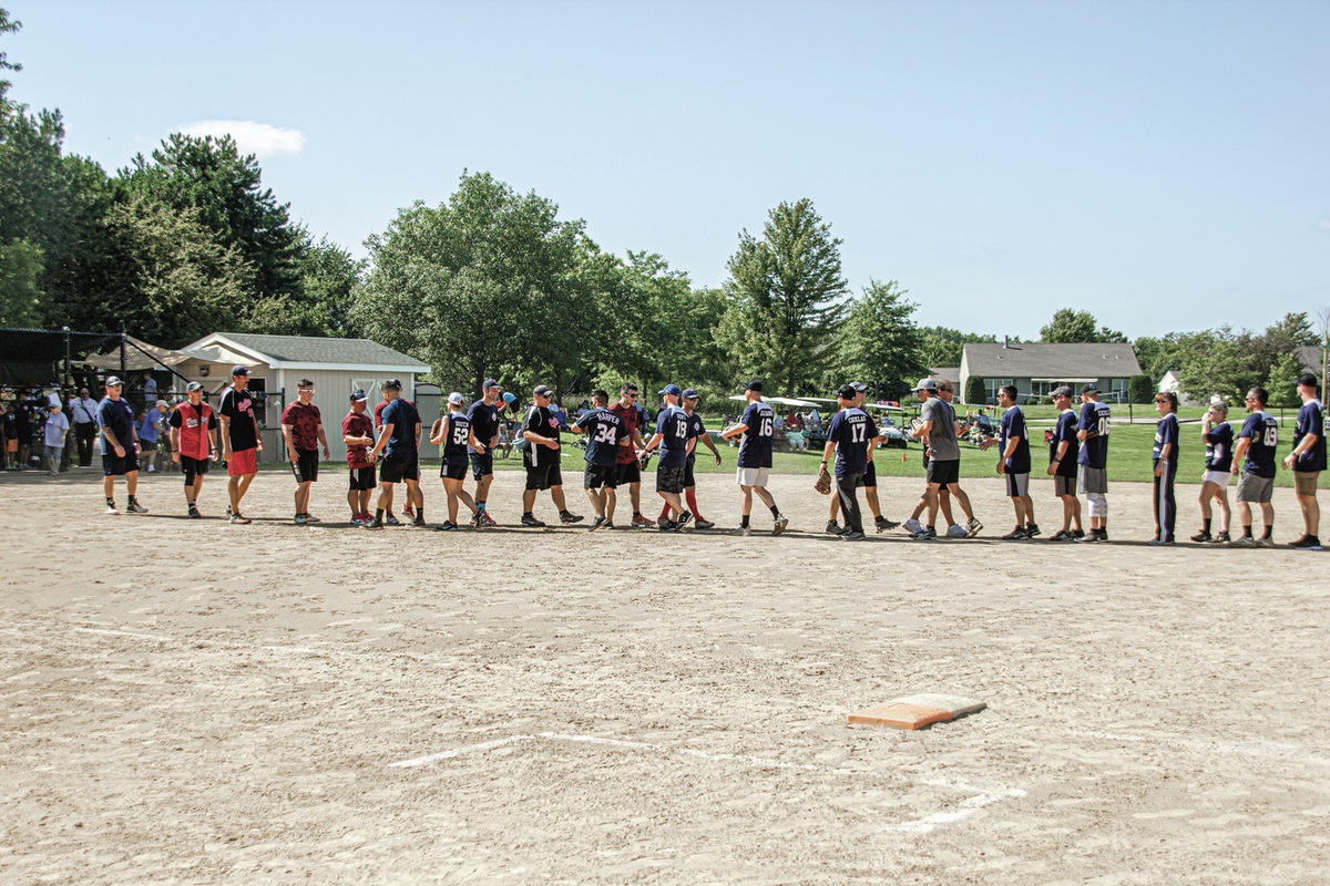 Sun City softball players and Huntley first responders wrap up 2022’s National Night Out with a round of handshakes. (MSDN File Photo)