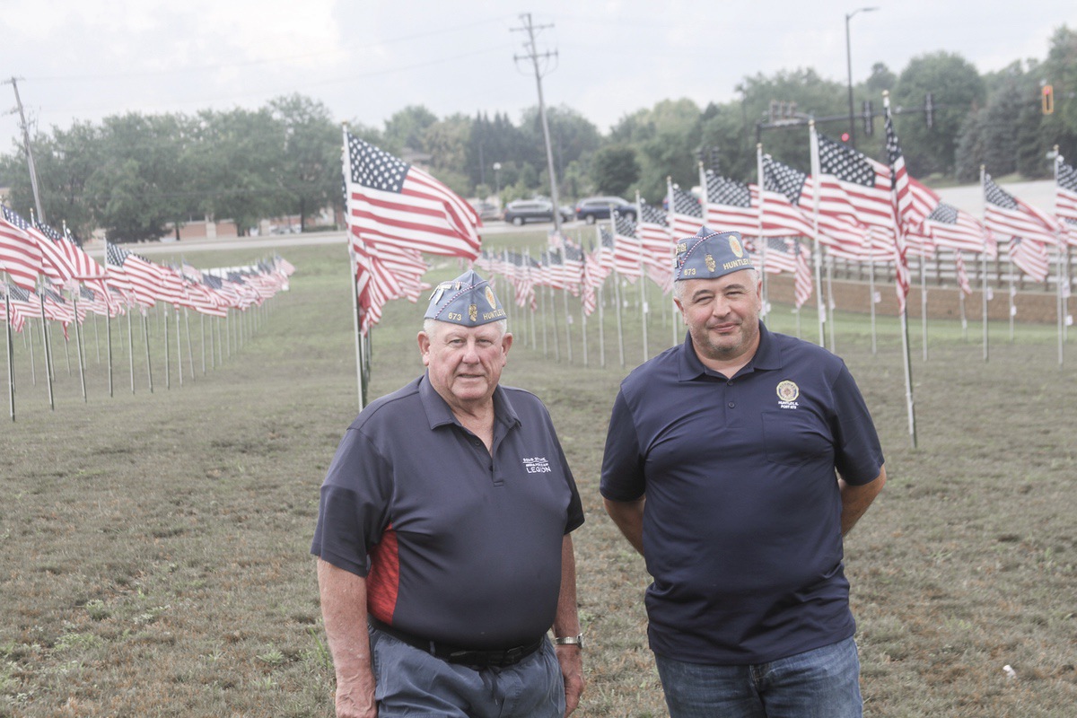 Huntley Sons of American Legion Post 673 Squadron Commander George Lewerenz, left and Finance Officer Kevin Goers stand at the Ruth Family Freedom Silo. (Photo by Steve Peterson/My Huntley News)