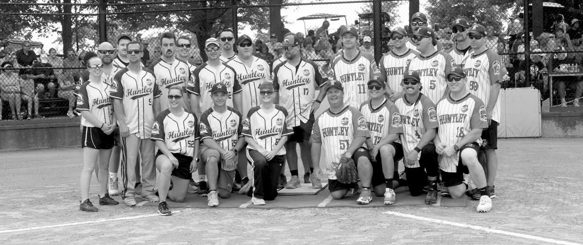 Huntley Fire Department and Huntley Police Department softball teams pose before the annual First Responders National Night Out game at Sun City’s Veterans Memorial Field. (Photo by Steve Peterson/My Huntley News)