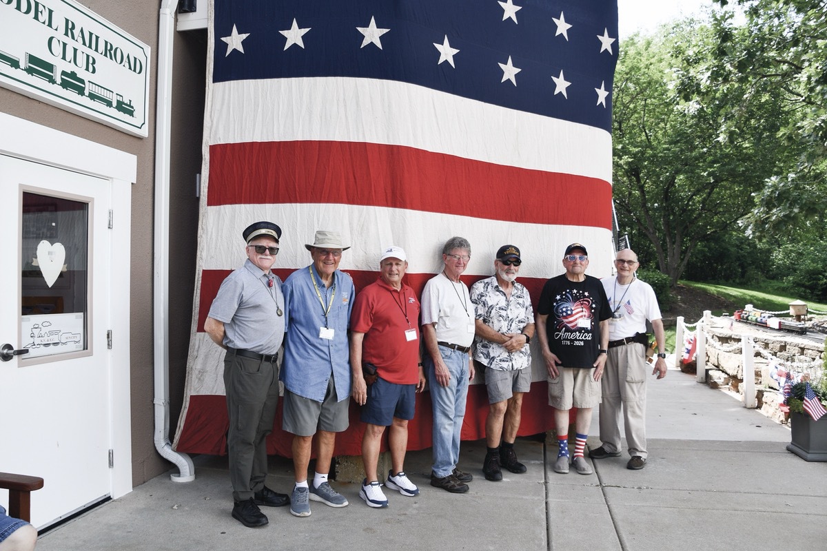 Model Railroad Club Members (L to R) D. Applegate, D. Hattendorf, D. Levy, R. Greenspan, D. Von Burgen, D. Svoboda, and R. Melka outside the patriotically decorated clubhouse. (Photo by Christine Such/My Sun Day News)