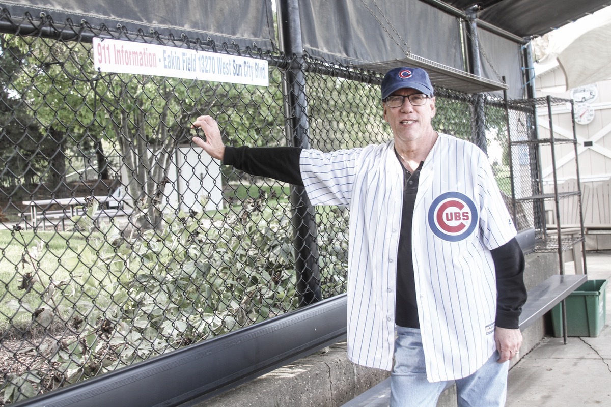 Sun City resident Bob Mianulli stands at the third base dugout at Sun City Veterans Memorial Field. (Photo by Steve Peterson/My Sun Day News)