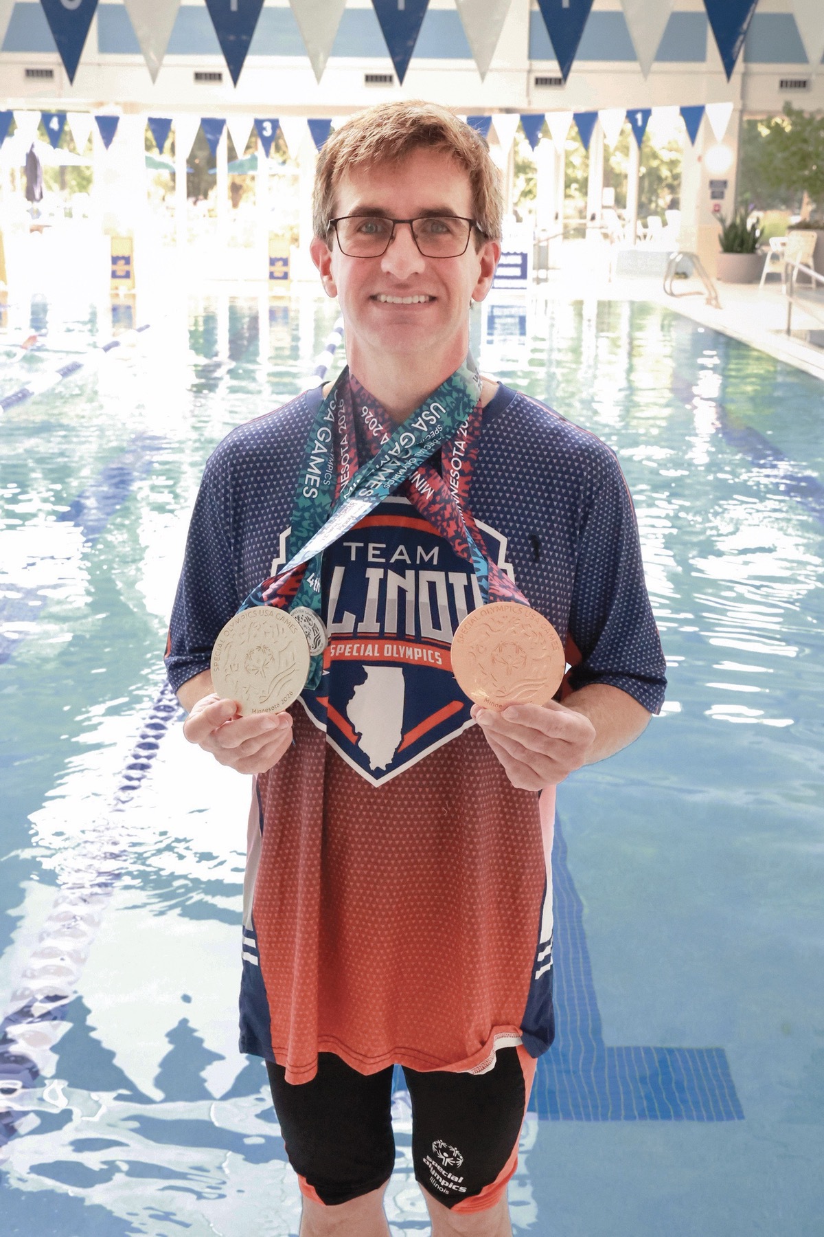 Rochlitz shows off his silver and bronze medals.