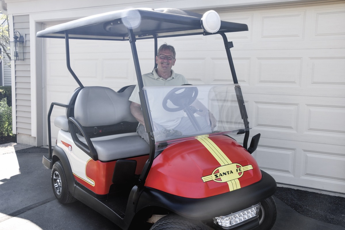Dave McElwain has been a train lover all his life. And in his teens, he modified cars. Here he brings both passions together with this modified golf cart made to look like a train. (Photo by Christine Such/My Sun Day News)